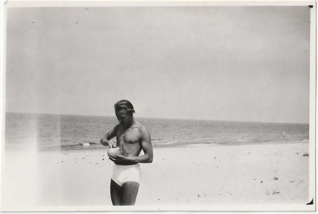 Man in Swimsuit Eating Coconut - Snapshot, c. 1950s